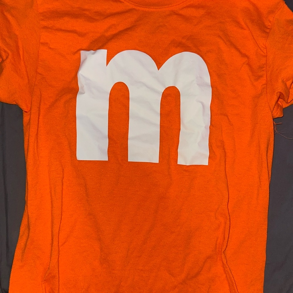 Bright orange t shirt with m on front